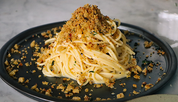 A plate of pasta with breadcrumbs 