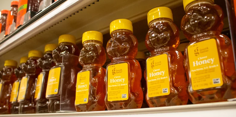 Bear-shaped honey bottles on shelve